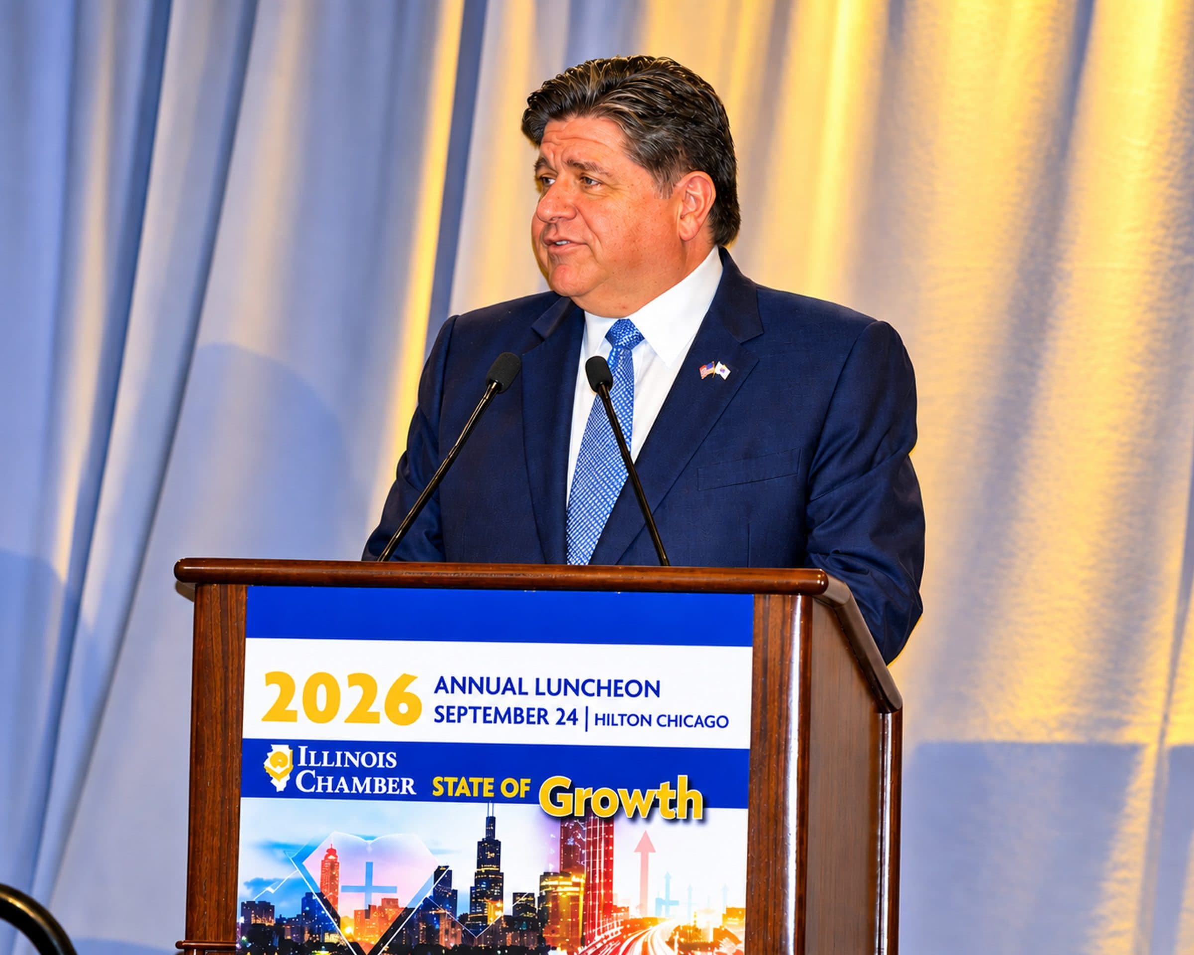 A speaker addresses the luncheon from the 2026 Annual Luncheon podium.