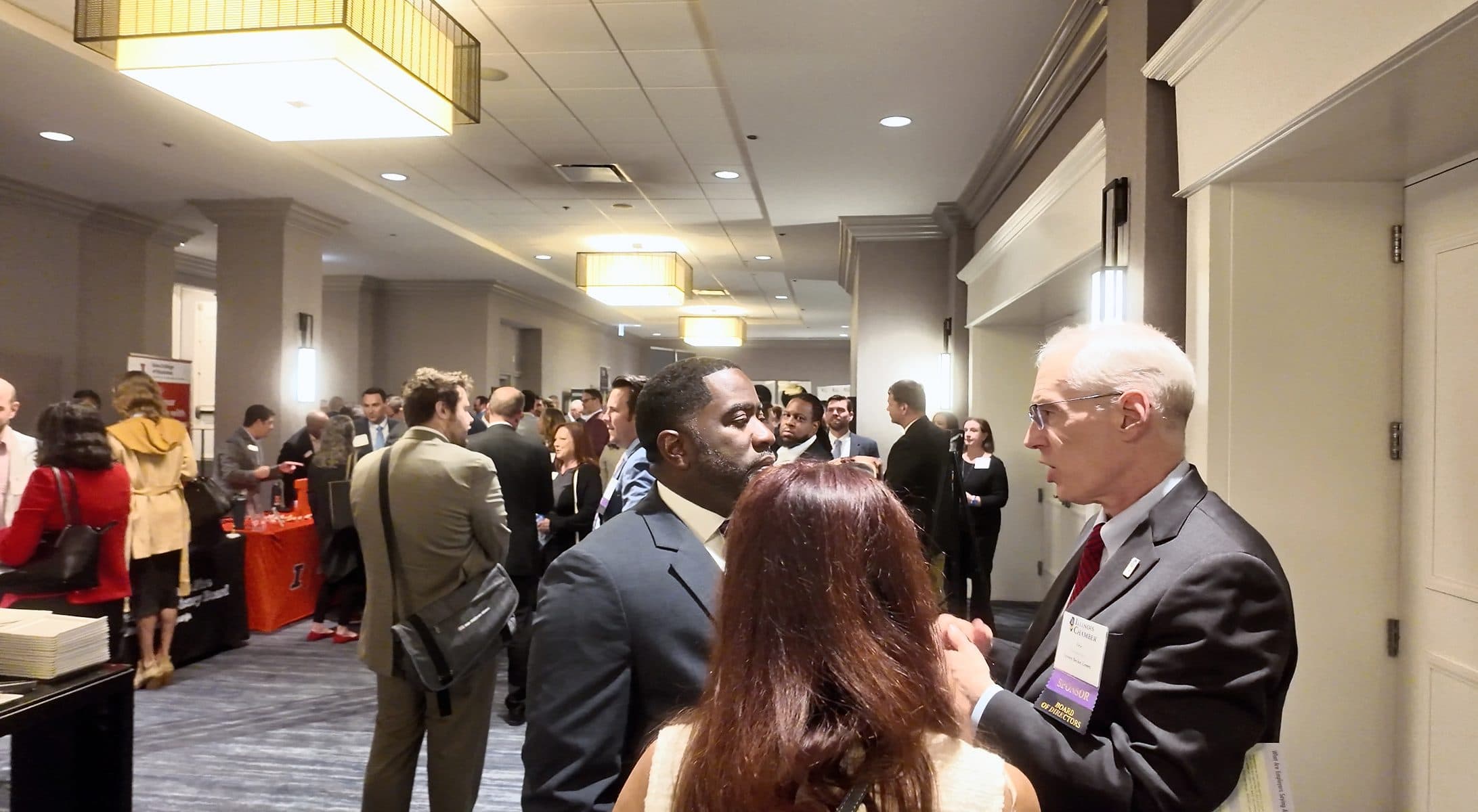 Attendees mingle in the crowded expo hallway.