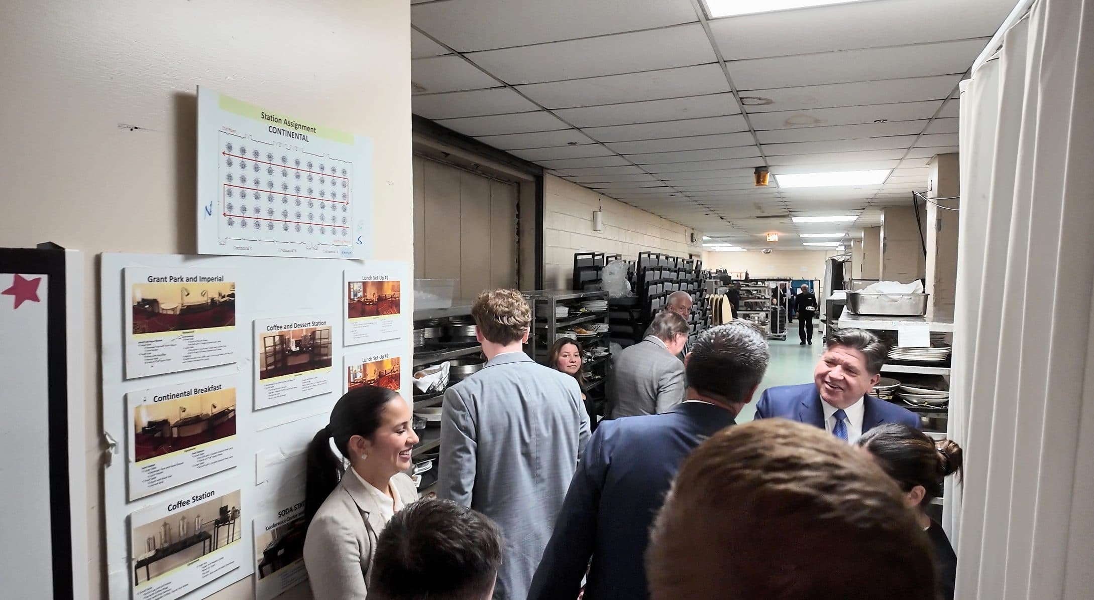 Guests gather in the backstage corridor before the program.
