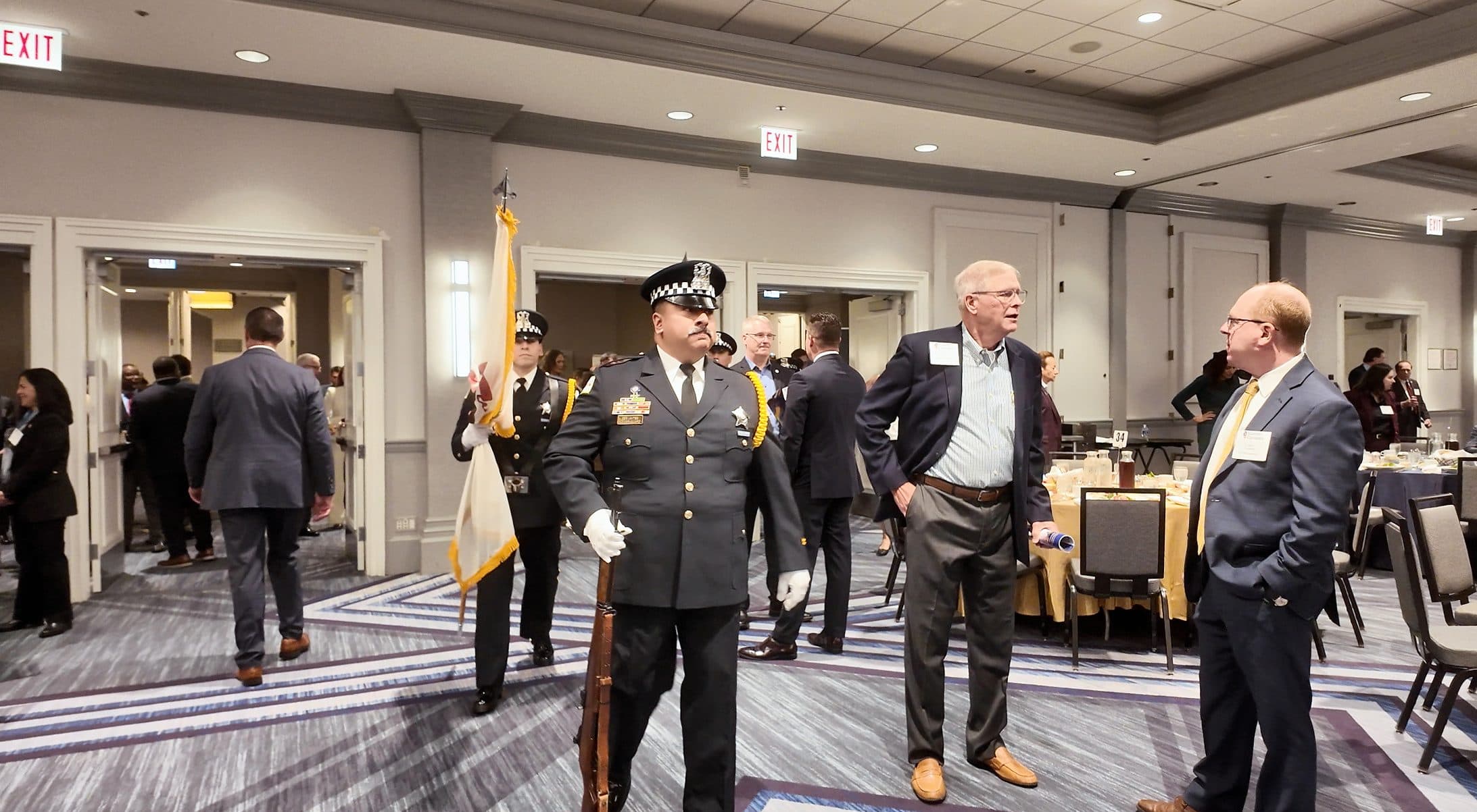 Police honor guard members and guests in the ballroom before the program.