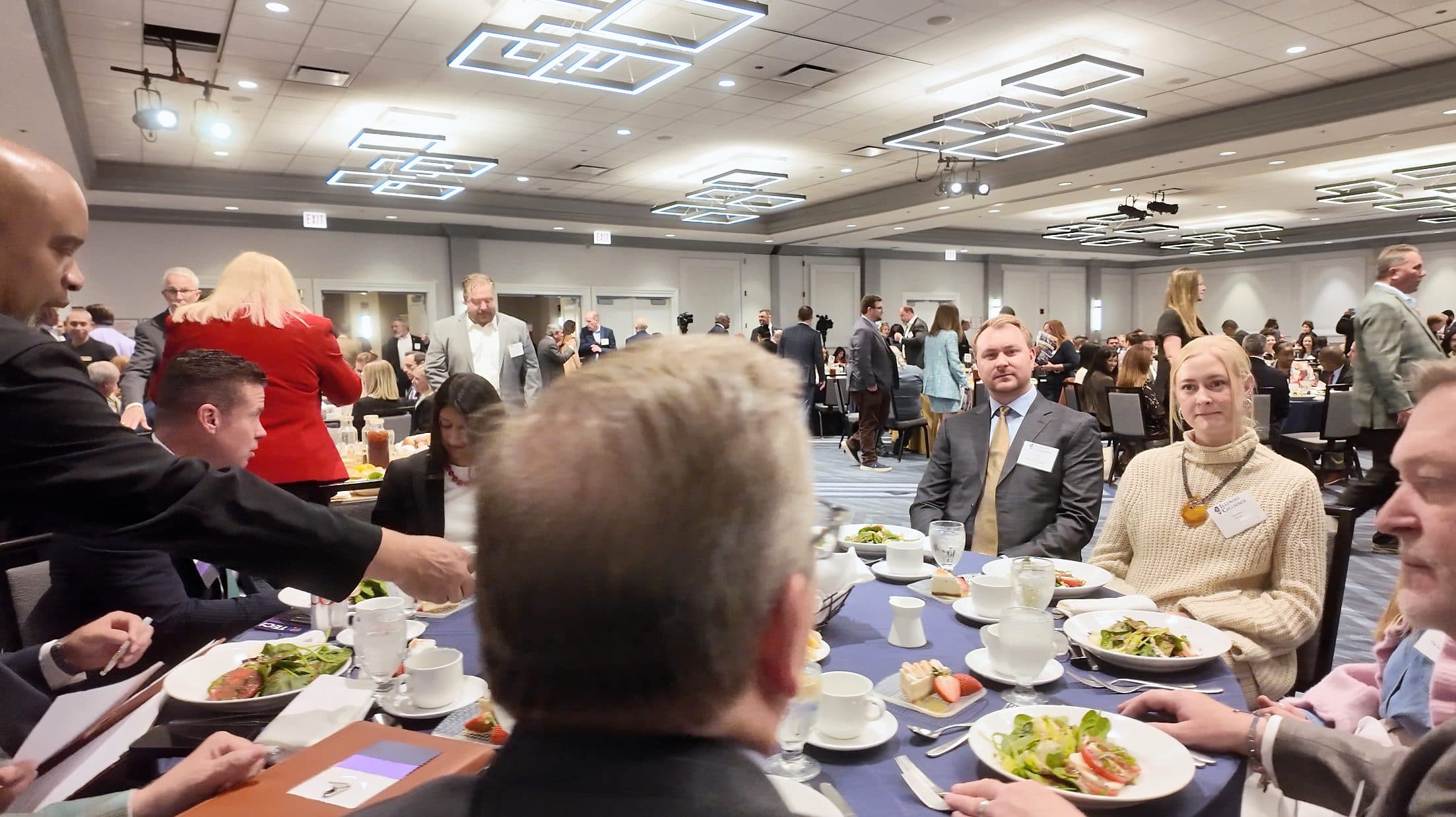 Guests at a luncheon table with salads.