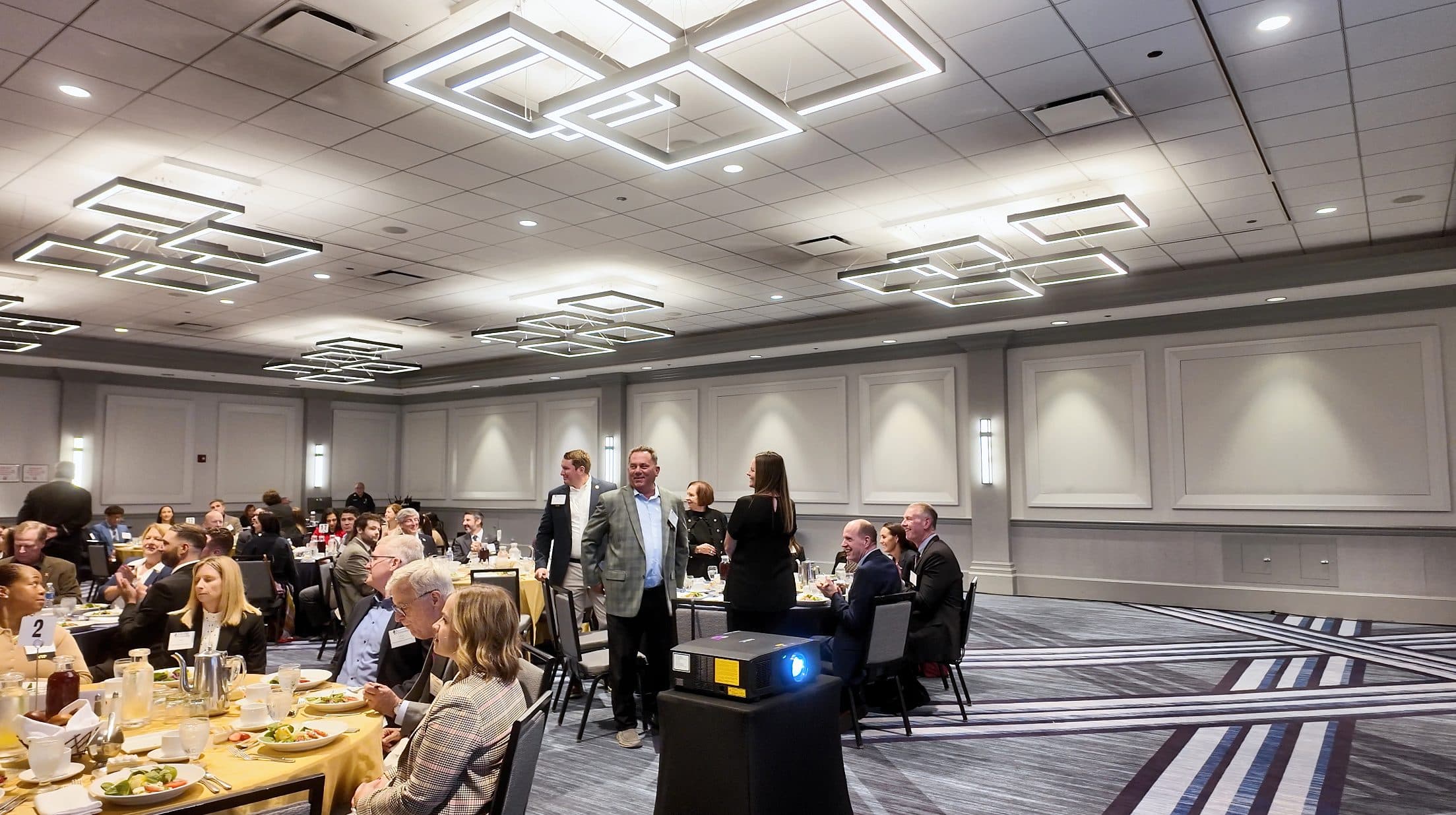 Attendees seated at round tables during the luncheon program.