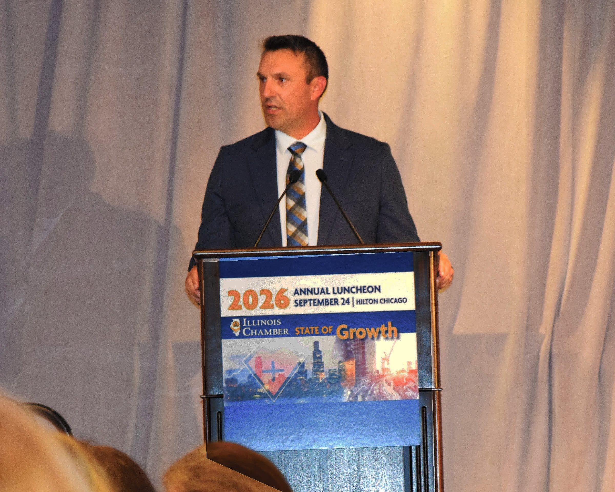 A speaker at the podium during the program.