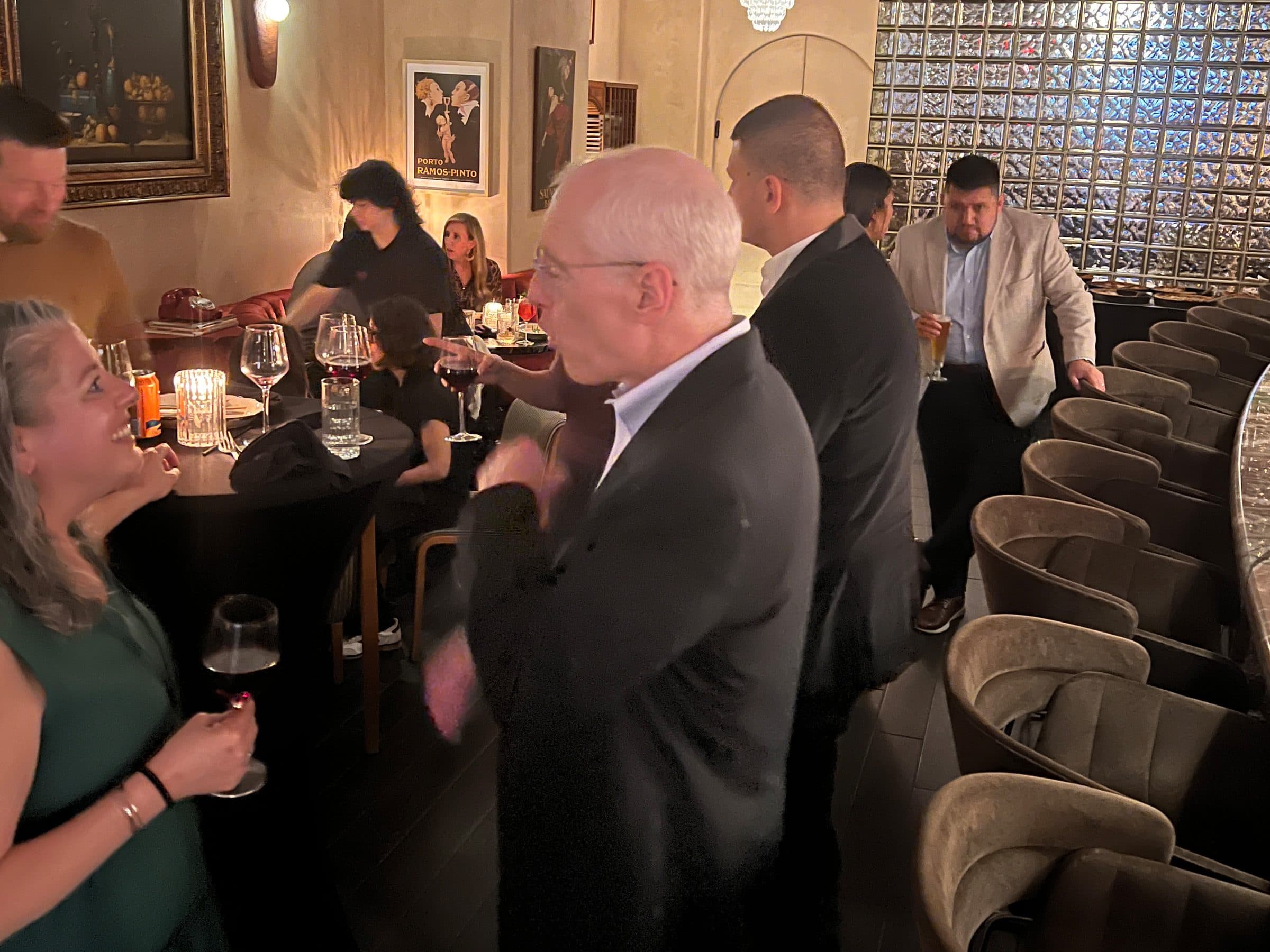 Guests talk over drinks at the board reception.